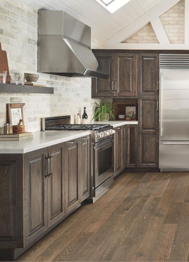 beautiful rustic kitchen with new floors, countertops, cabinets, and tile backsplashes